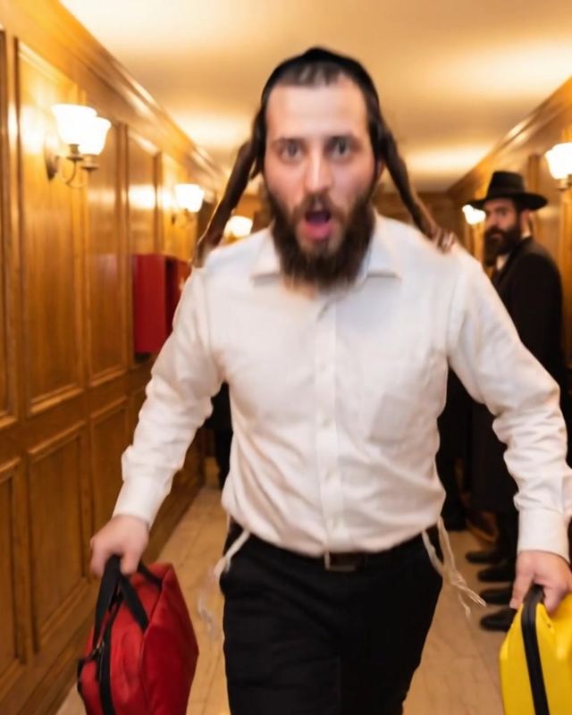 A Chassidish man runs through a shul hallway carrying a first-aid kit